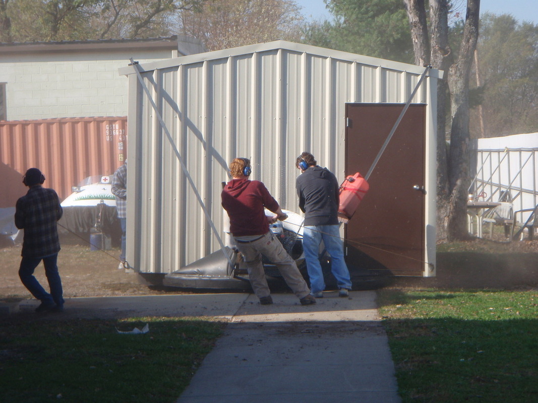 building floats down sidewalk